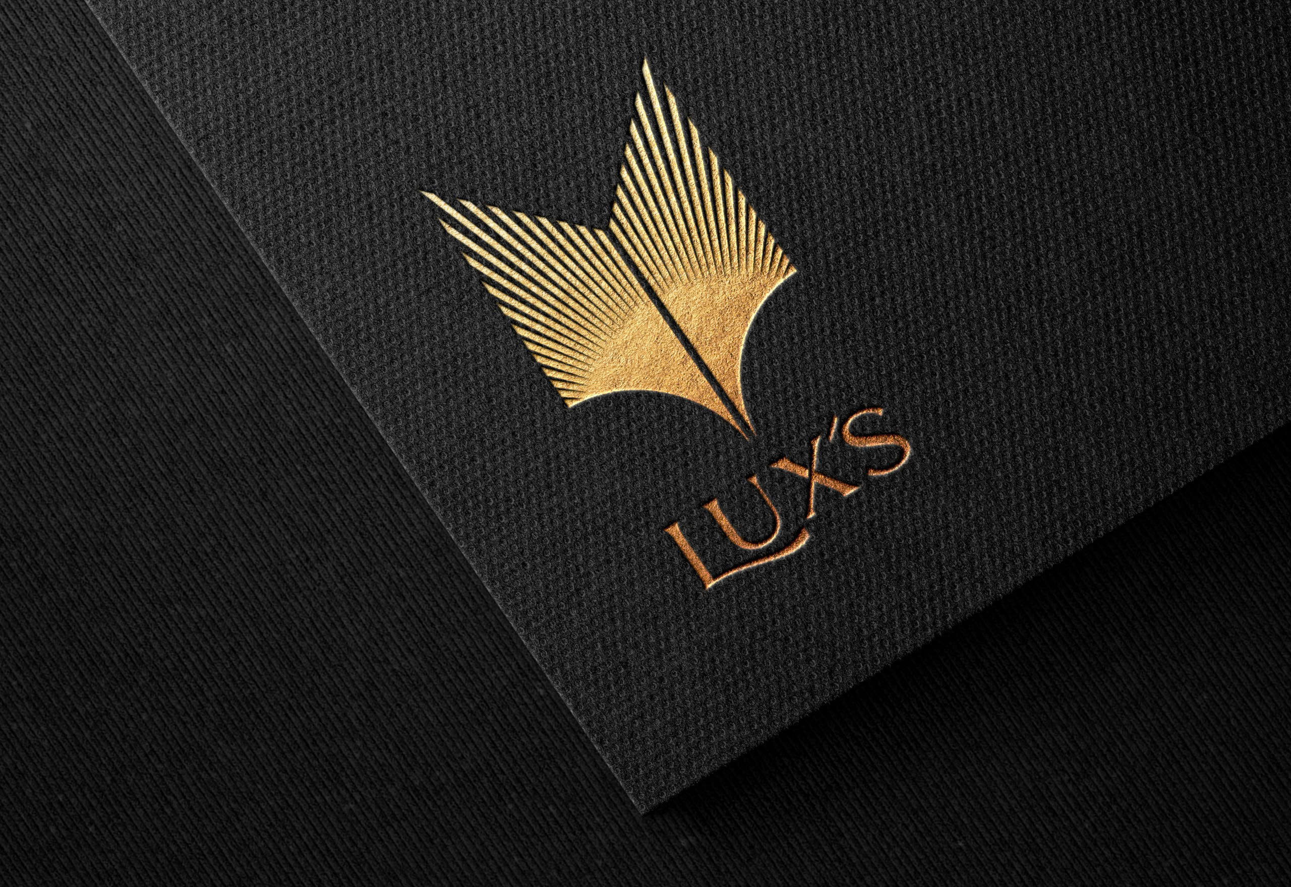 LUX'S gold logo on black material